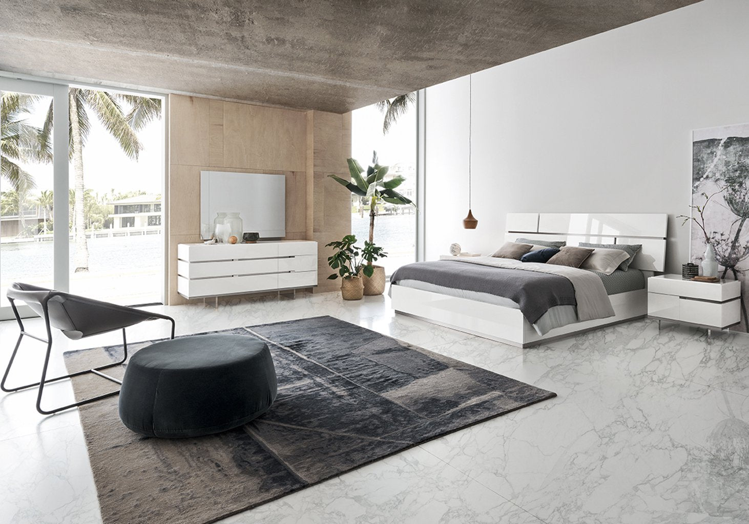 Artime modern bedroom set with gray rug, and large windows.