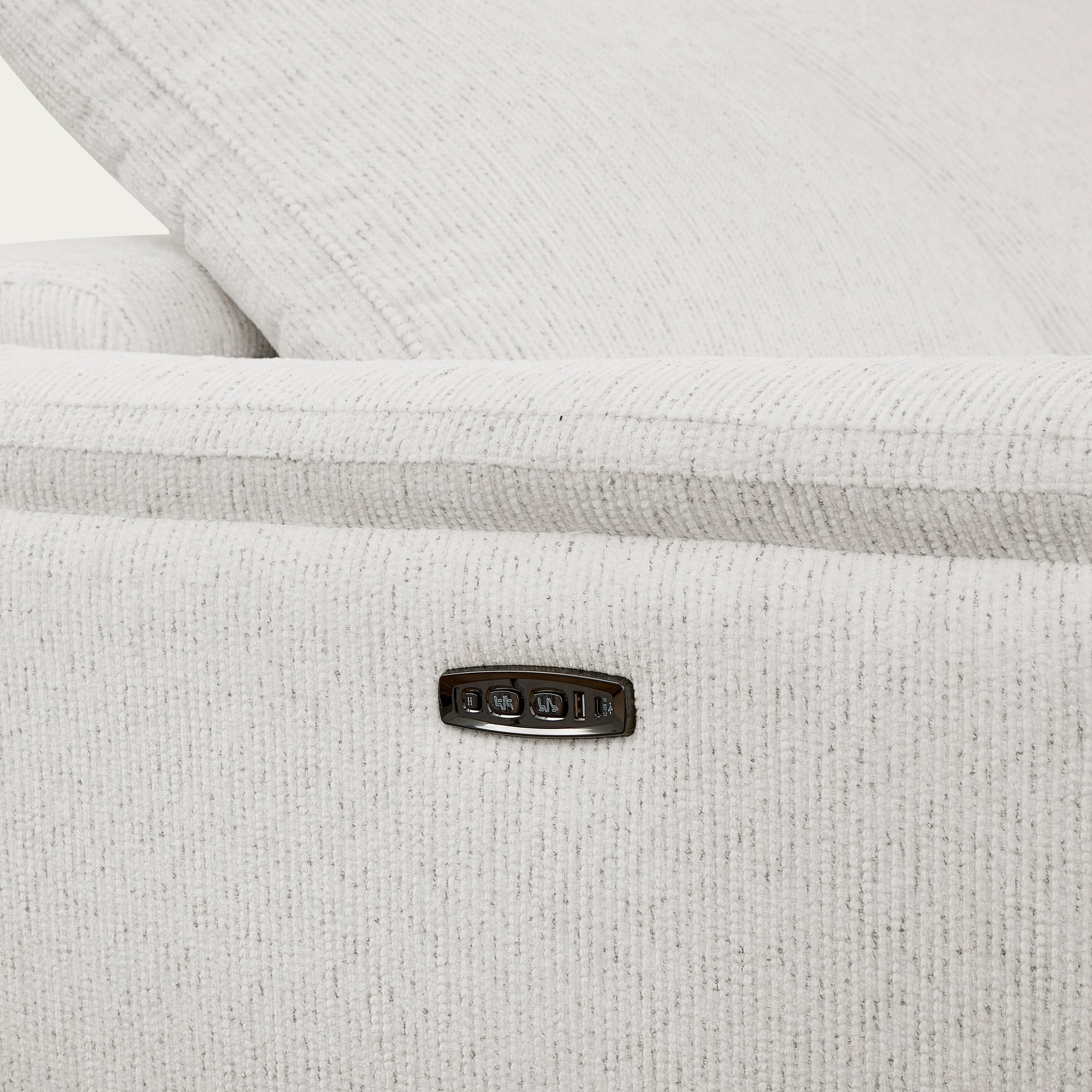 Close-up of a textured white fabric reclining sofa