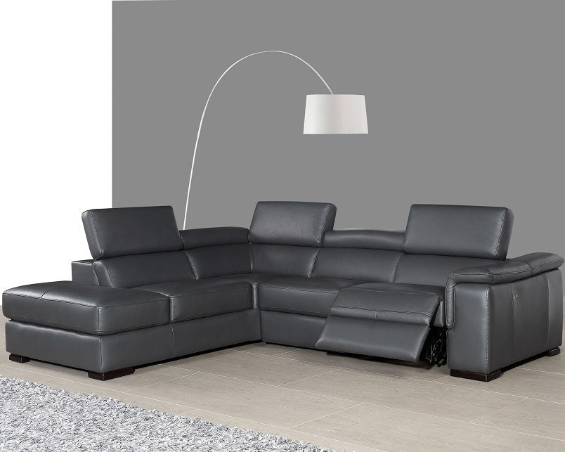 The Agata gray sectional sofa in a living room setting with a lamp and rug.