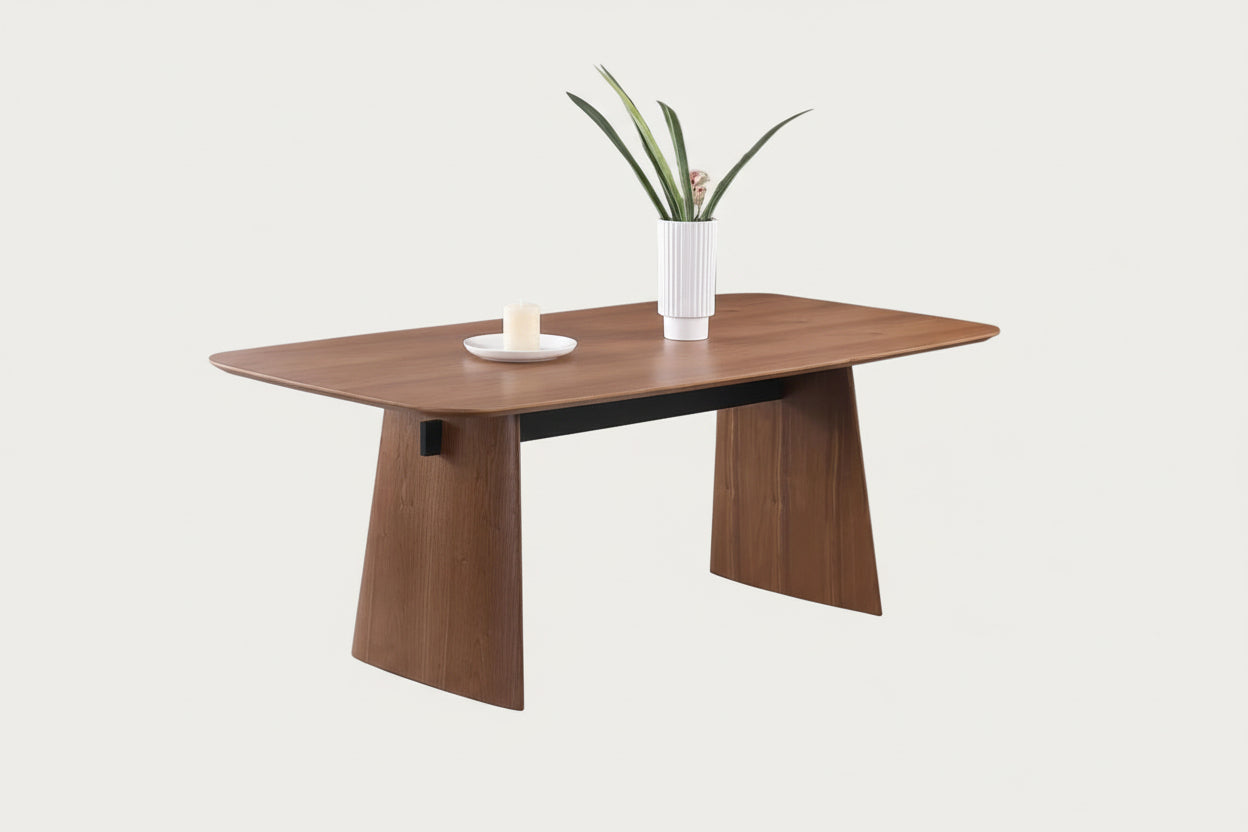 Eden wooden dining table with a plant and plates on a white background