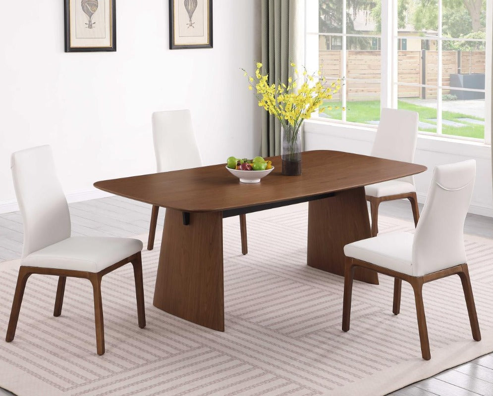 Eden dining room with a wooden table and white chairs near a window.