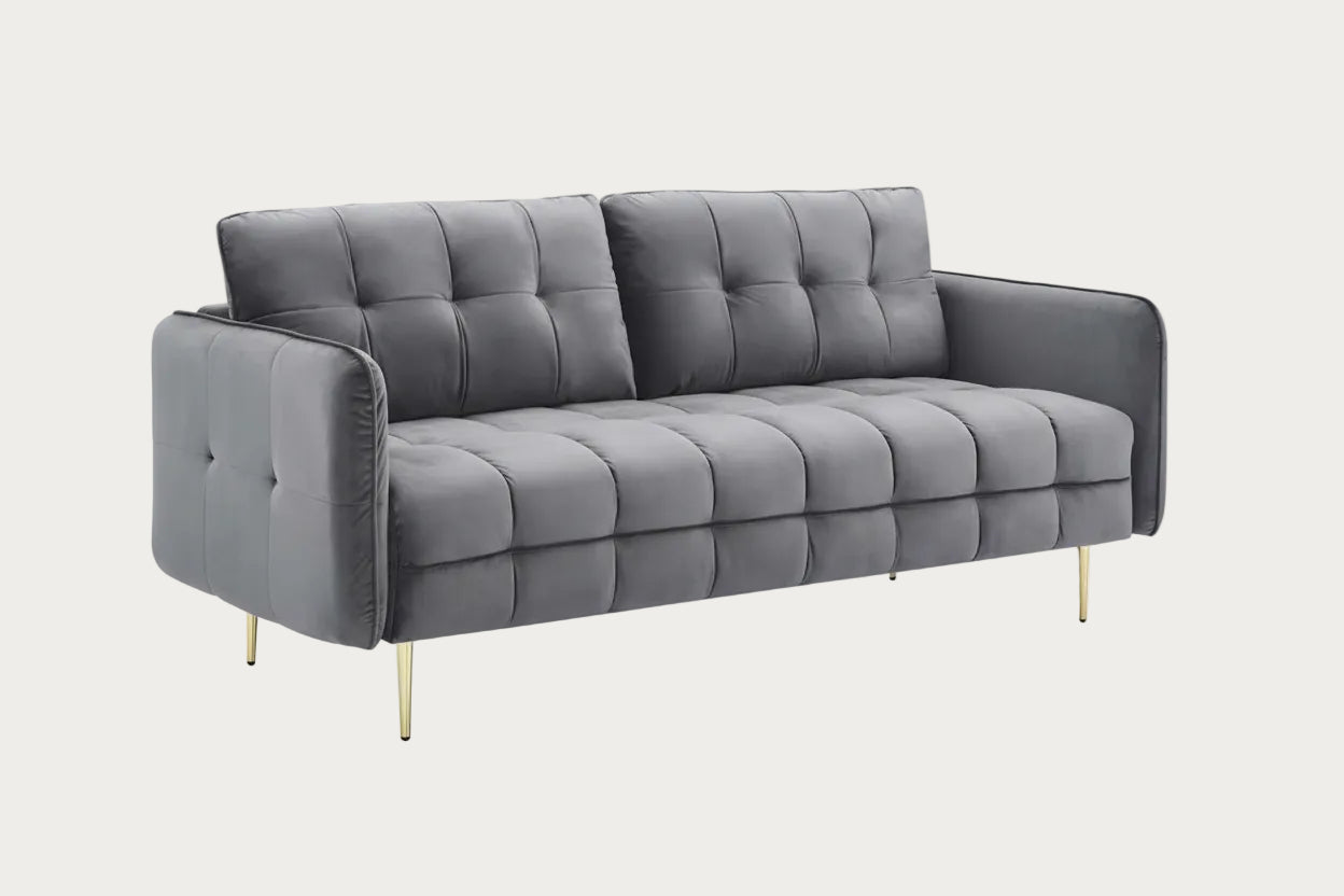 Gray sofa with tufted design on a white background