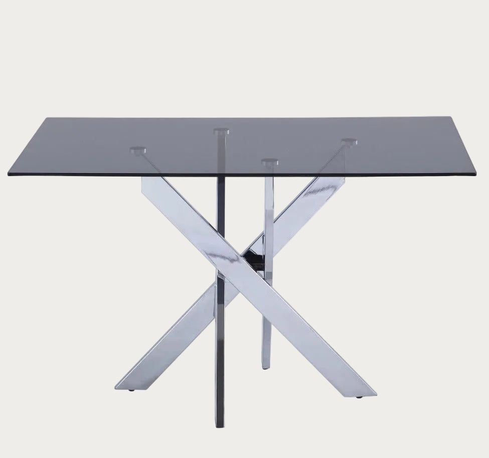 Genevieve dining able with a glass top and metal frame on a white background