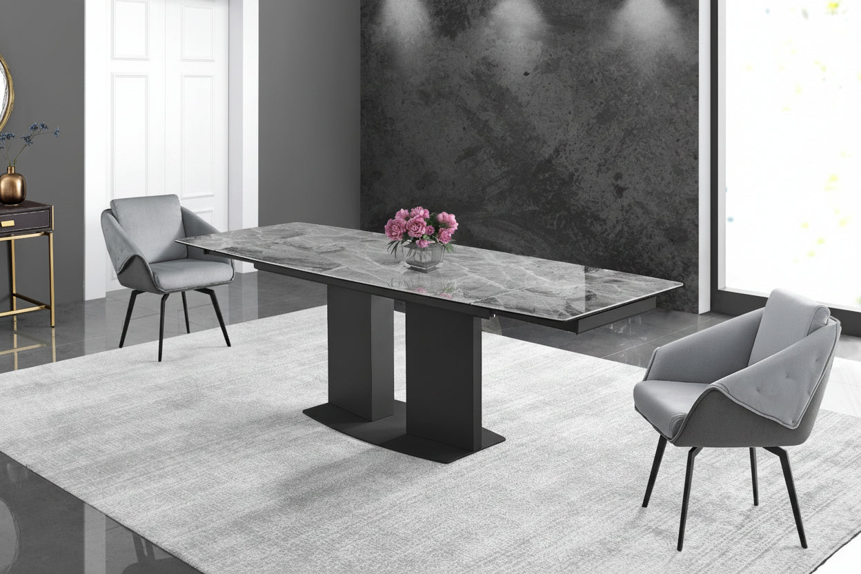 Dining table with black legs in a modern room setting with chairs and decor.