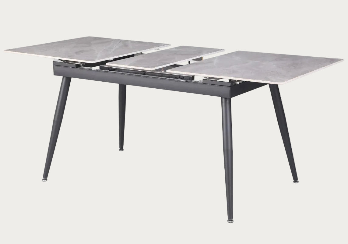 Judith dining table with marble-like top and metal legs.