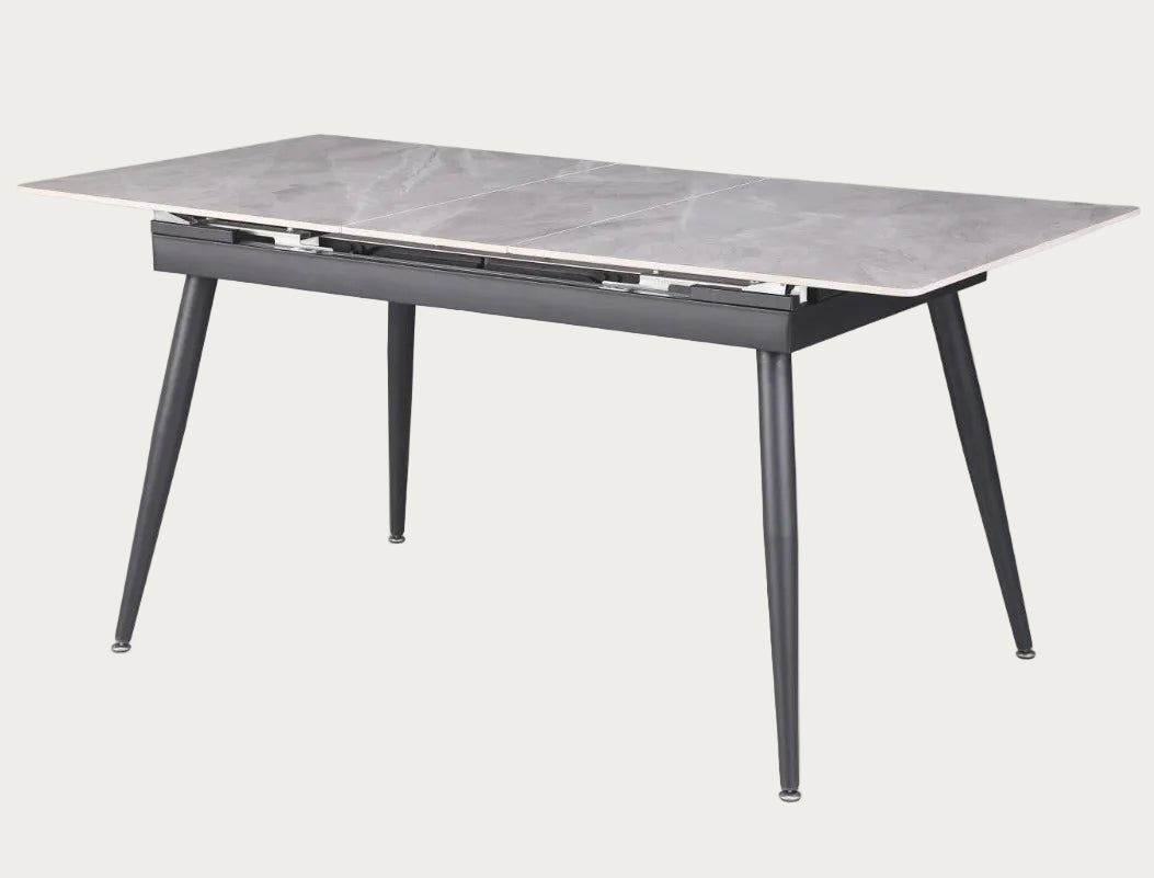 Judith dining table with marble-like top and black metal legs.