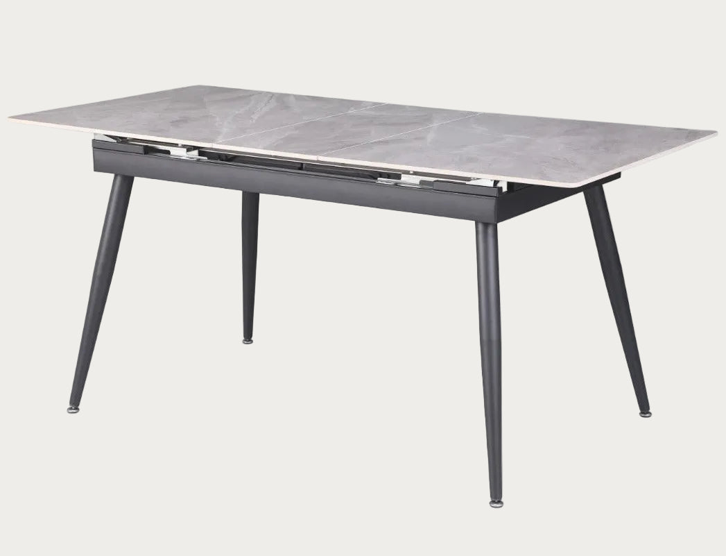 Judith dining table with marble-like top and black metal legs.