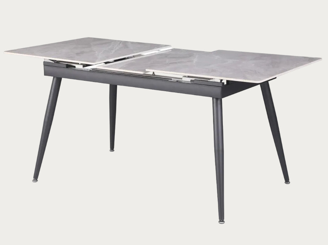 Judith dining table with marble-like top and metal legs.