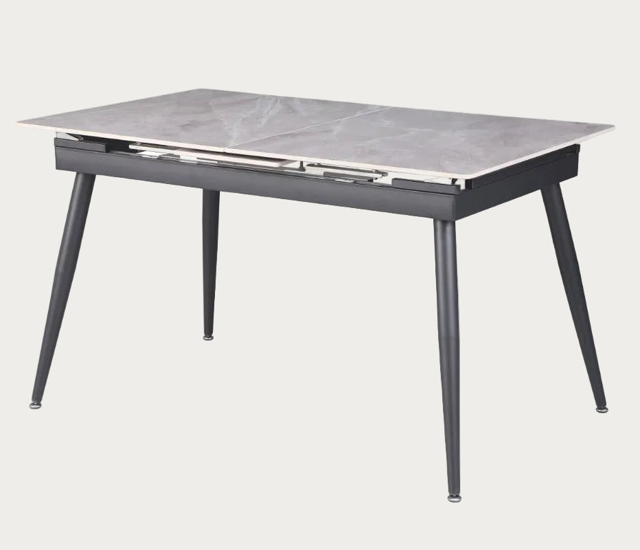 Judith dining table with marble-like top and black legs on a white background