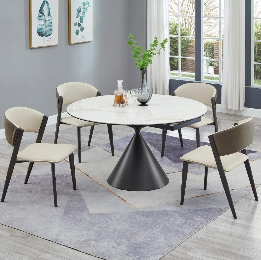 Juniper dining room with a round marble table and four chairs on a gray rug.