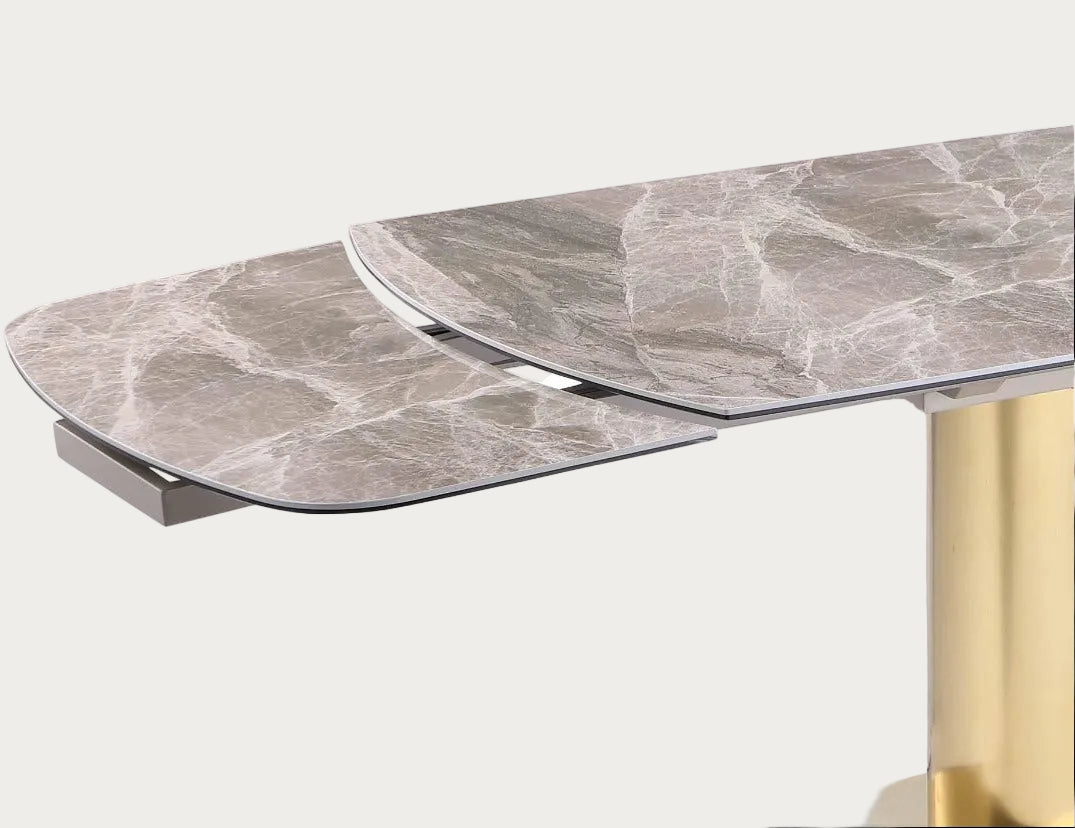 Karla dining table with marble-like top and gold leg.