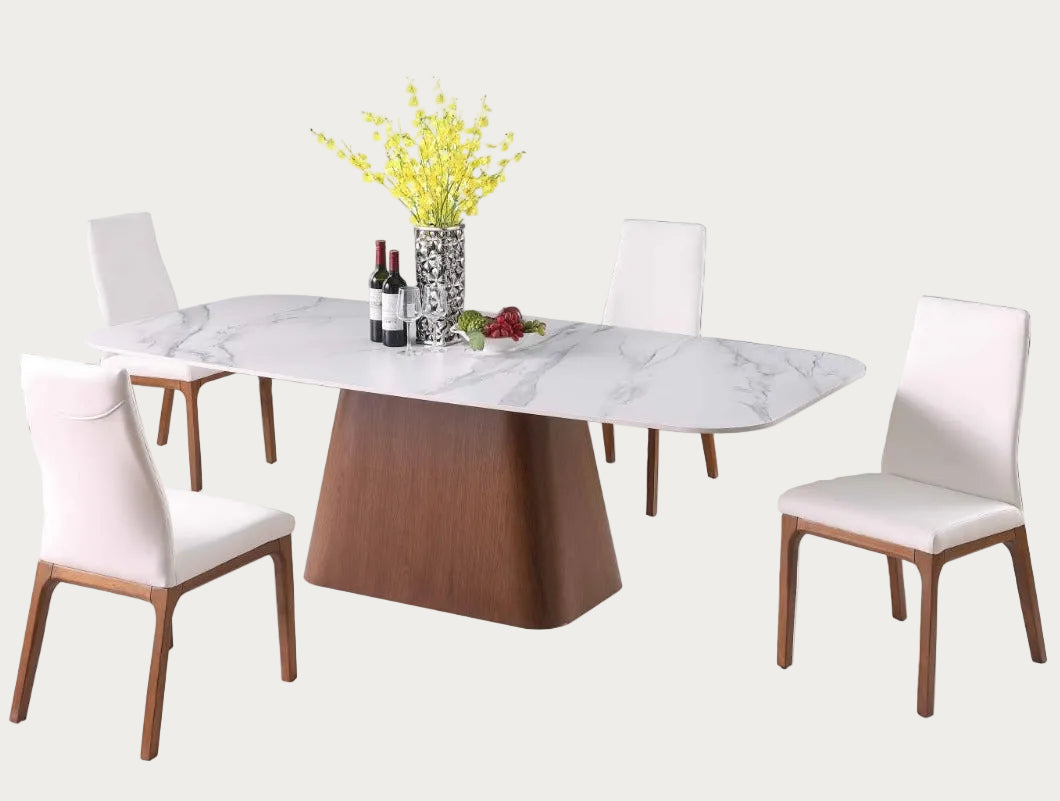 The Kenza Rosario dining room set with a marble top and wooden base, surrounded by white chairs.