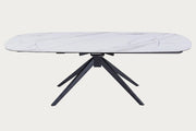 Nicole white oval table with black metal legs on a white background