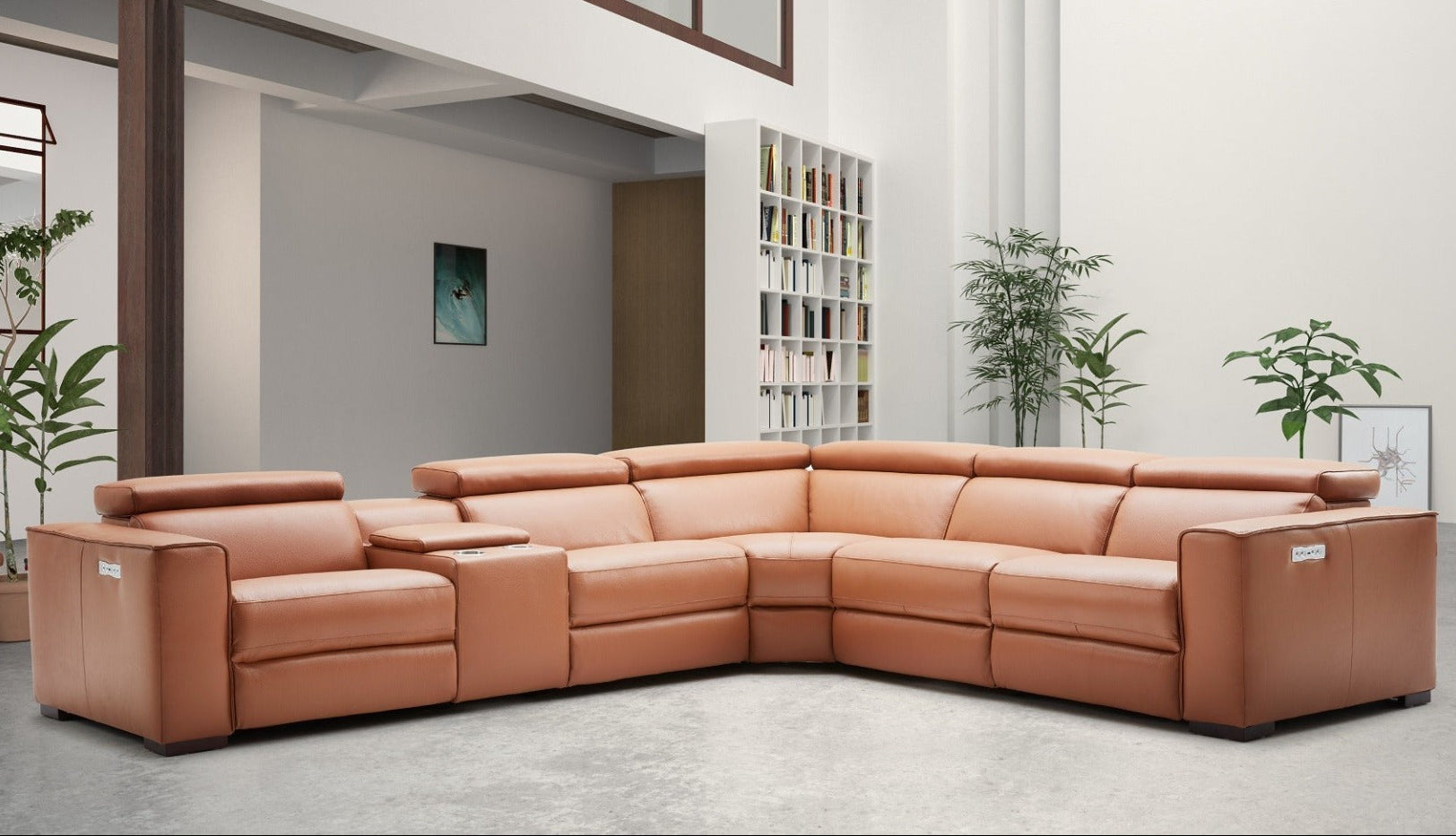 Caramel leather sectional sofa in a modern living room setting with plants and bookshelves.