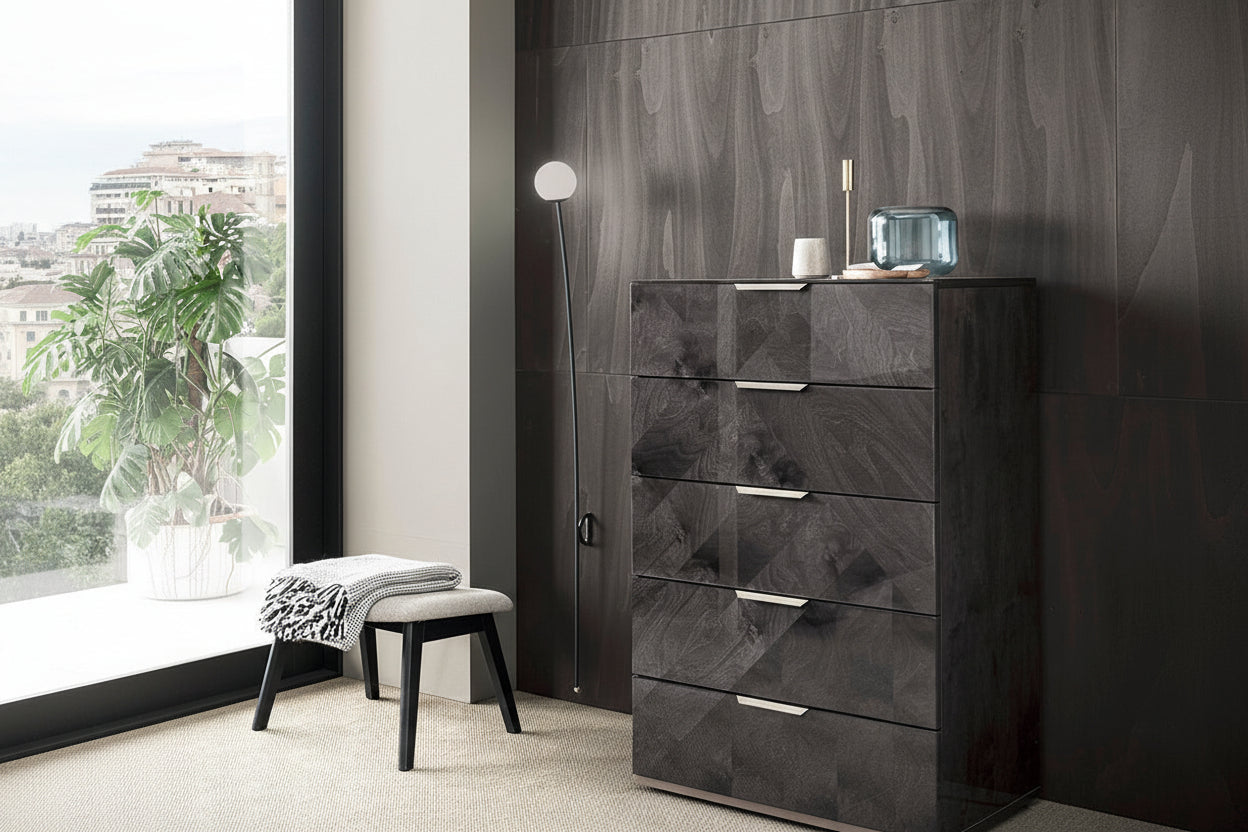 Modern black dresser against a patterned wall with a window in the background
